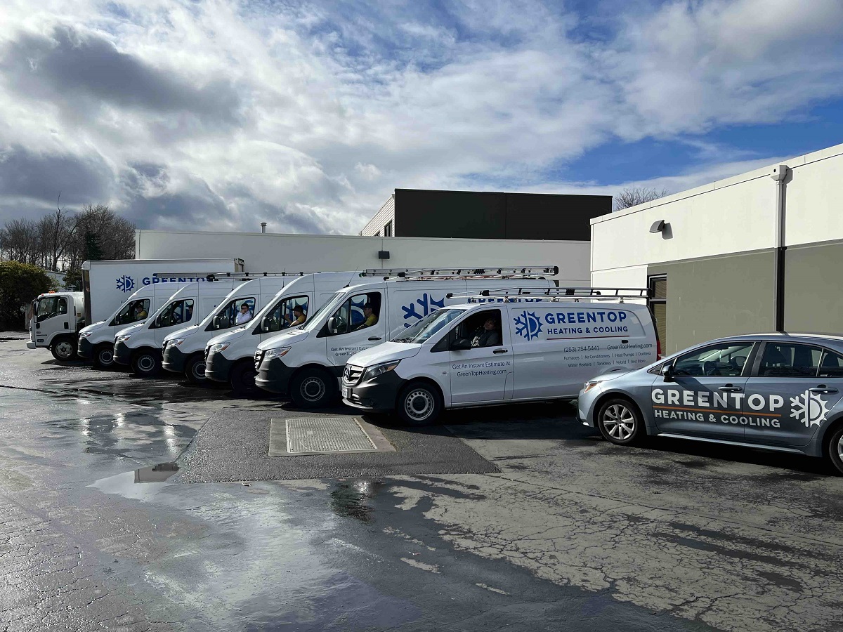 Freshly cleaned GREENTOP Heating service vehicles ready for dispatch